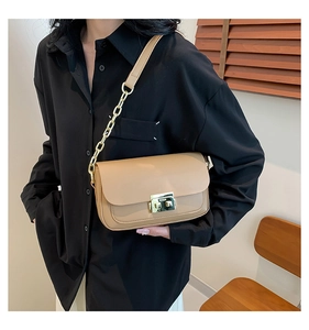 Close-up of the elegant khaki leather flap bag with a golden rectangular lock clasp