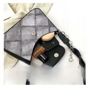 Silver checkered shoulder bag with floral chain showing phone and perfume capacity