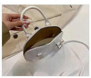 Top view of shell bag interior showing white crocodile pattern and fabric lining