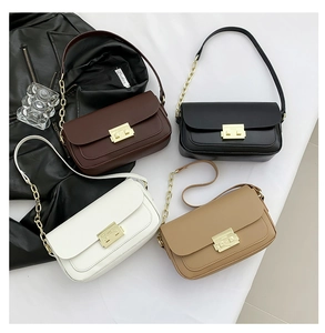 Flat lay of square flap shoulder bags in four colors with gold metal clasps and chain straps