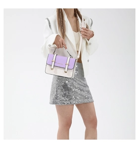 Detail of two-tone lilac and cream PU leather crossbody bag with metal buckle straps
