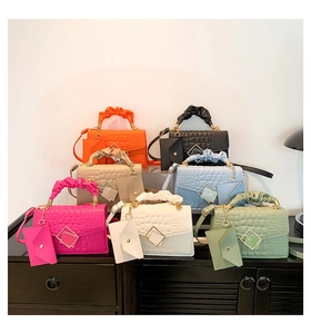 Detail showing colorful crocodile pattern handbags with matching small coin purses and pleated handles