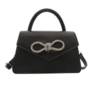 Elegant black faux leather crossbody bag with a sparkling rhinestone bow buckle decoration