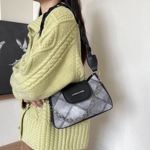 Chic black and grey plaid underarm bag with silver chain and woven shoulder strap