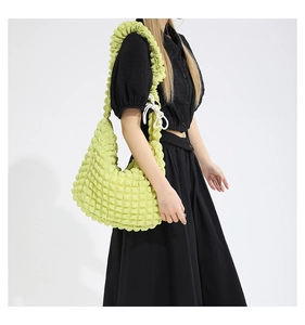 Detail of lime green popcorn texture shoulder bag with stylish drawstring knots
