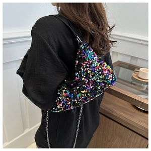Detail of colorful sequin hobo bag featuring mixed blue, pink and yellow hues on a model
