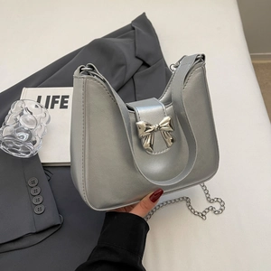 Minimalist silver metallic shoulder bag with bow detail and chain strap for women