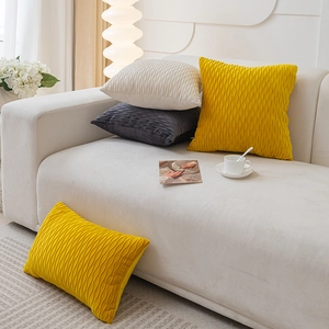 Nordic velvet cushion cover with wave pleats in yellow, beige and grey on a sofa