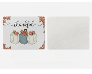 Detail of linen texture placemat featuring Thankful text and autumn pumpkin patterns