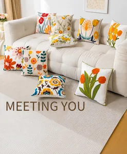 Detail shot of multi-color floral embroidery patterns on square cushion covers