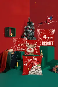 Detailed view of red Christmas pillow covers with Santa and Reindeer on green display