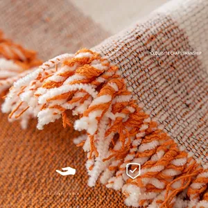Chenille tulip sofa cover with elegant tassels and orange knit texture detail