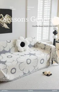 Detail of chenille sofa cover with large daisy pattern and elegant long fringes