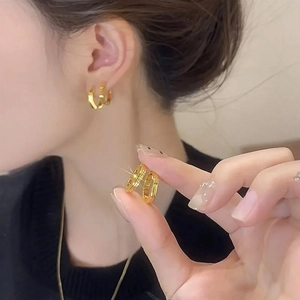 Textured gold hexagonal geometric hoop earrings with a bamboo-inspired joint design