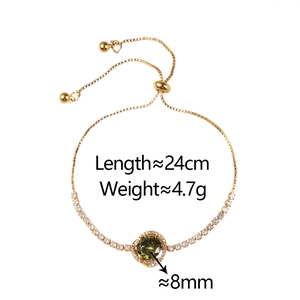 Detail of adjustable gold bracelet featuring an 8mm green zircon with halo setting