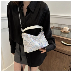 Close-up of sparkling white sequin handbag with silver chain strap and leather handle