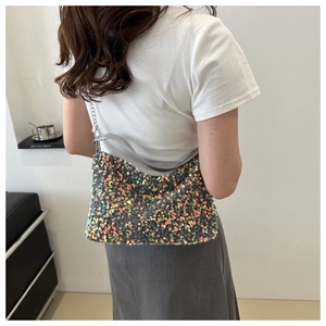 Silver sequin shoulder bag with chain strap shown on model for stylish casual outfits