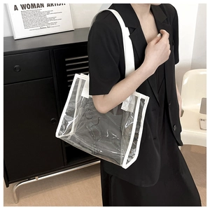 Detailed shot of transparent PVC tote bag with white webbing trim on model