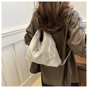 Silver metallic wrinkled tote bag with butterfly ornament and stylish chain details