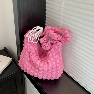 Pink popcorn textured shoulder bag with ruched design and white drawstring detail