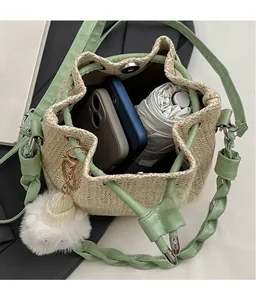 Detail view of woven bucket bag interior showing capacity for phones and a folding umbrella