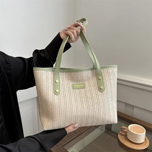 Large capacity beige straw woven tote bag with green handles and stylish brand logo