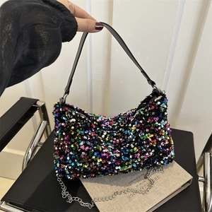 Colorful sequin shoulder bag with chain strap and top zipper in a stylish hand-held pose