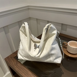 Large capacity cream tote bag with metallic butterfly detail and elegant pleated texture
