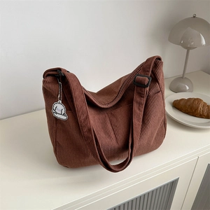 Brown corduroy large tote bag with cute cloud pendant on a minimalist table set