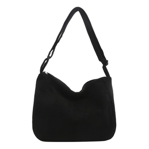Minimalist black corduroy crossbody tote bag with adjustable strap and front pocket