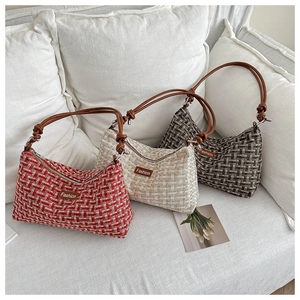 Detail of tweed crescent bags with leather knot straps and 'Fashion' label in various colors