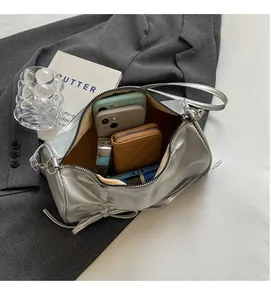 Detail shot of silver leather pillow bag interior showing spacious storage for daily essentials