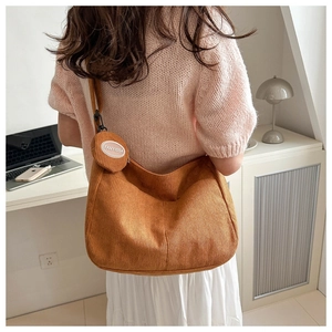 Detailed texture of caramel corduroy tote bag with round FANYISSA coin purse charm