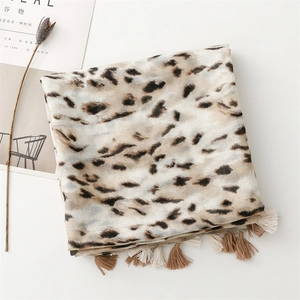Detailed view of leopard print scarf with soft fringe tassels and breathable fabric