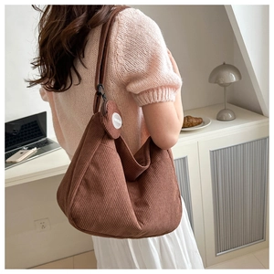 Close-up of caramel brown corduroy hobo bag with a matching detachable round coin purse