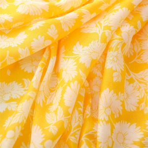 Close-up of yellow floral cotton linen scarf with small white daisy prints and texture