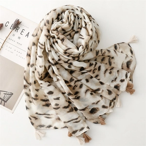 Detail of leopard print cotton linen scarf with soft tassels and natural texture
