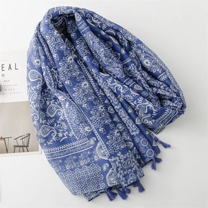 Blue linen-feel scarf with white paisley floral patterns and decorative tassels