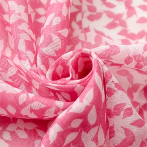 Macro detail of breathable pink leaf pattern fabric with soft fringe texture