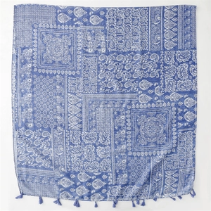 Detail of blue paisley and floral patchwork print shawl with decorative tassels