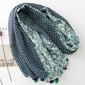 Close-up of cotton-linen feel scarf featuring floral prints and stylish fringe tassels