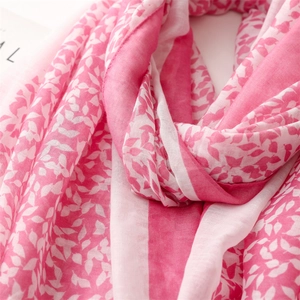 Detail of pink leaf floral patterns and striped texture on soft cotton linen shawl scarf