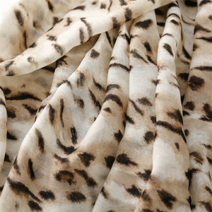 Close-up of leopard print cotton-linen scarf showing soft texture and detailed animal pattern