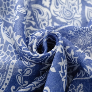 Detailed macro shot of blue and white paisley patterns on soft cotton-linen scarf