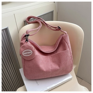 Pink corduroy hobo bag with matching round coin purse detail and adjustable strap