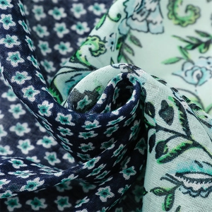 Macro detail of cotton-linen feel scarf showing mixed floral patterns and woven texture