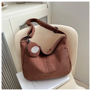 Detail of retro brown corduroy hobo bag with matching mini round coin purse and zipper