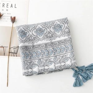Detail of blue floral print cotton-linen scarf with vintage ethnic tassel fringe design