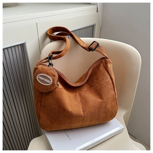 Detail of caramel corduroy hobo bag with matching coin purse and adjustable strap