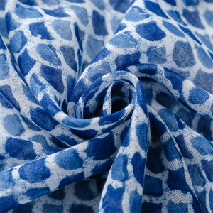 Macro shot of blue and white watercolor scale pattern on linen-touch scarf fabric
